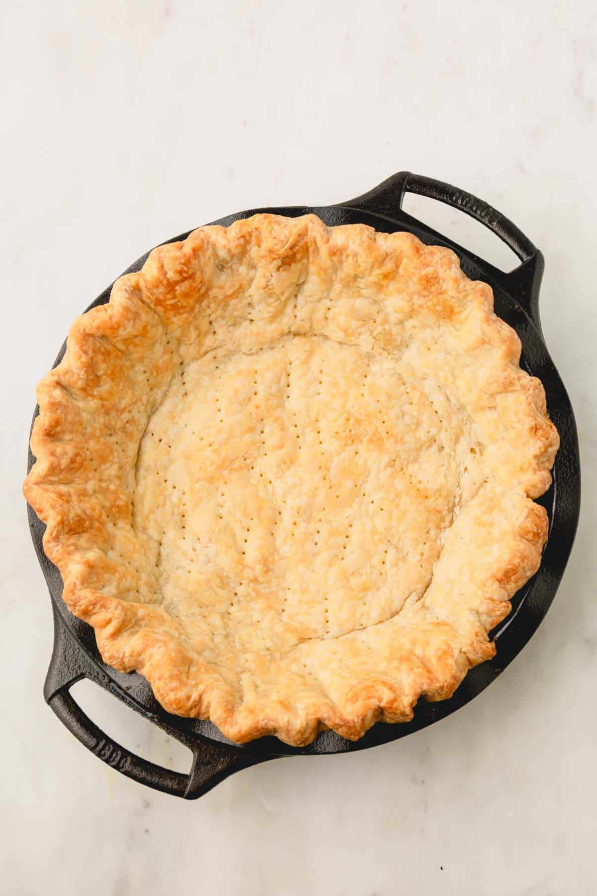 Blind baked pie crust in pie dish.