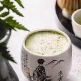 A matcha latte in a small cup.