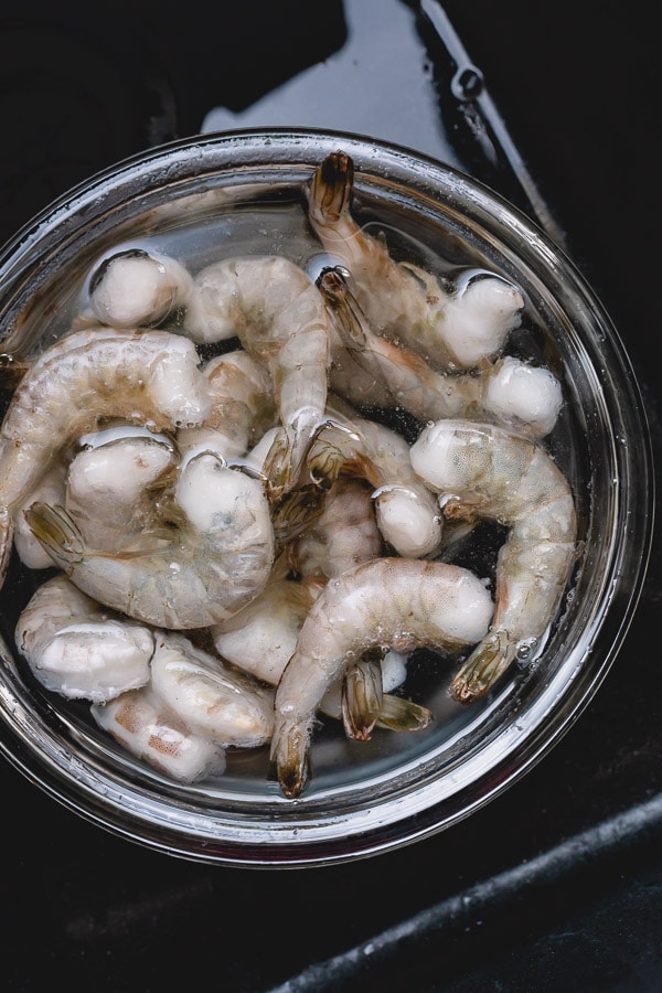 frozen shrimp in a bowl of water