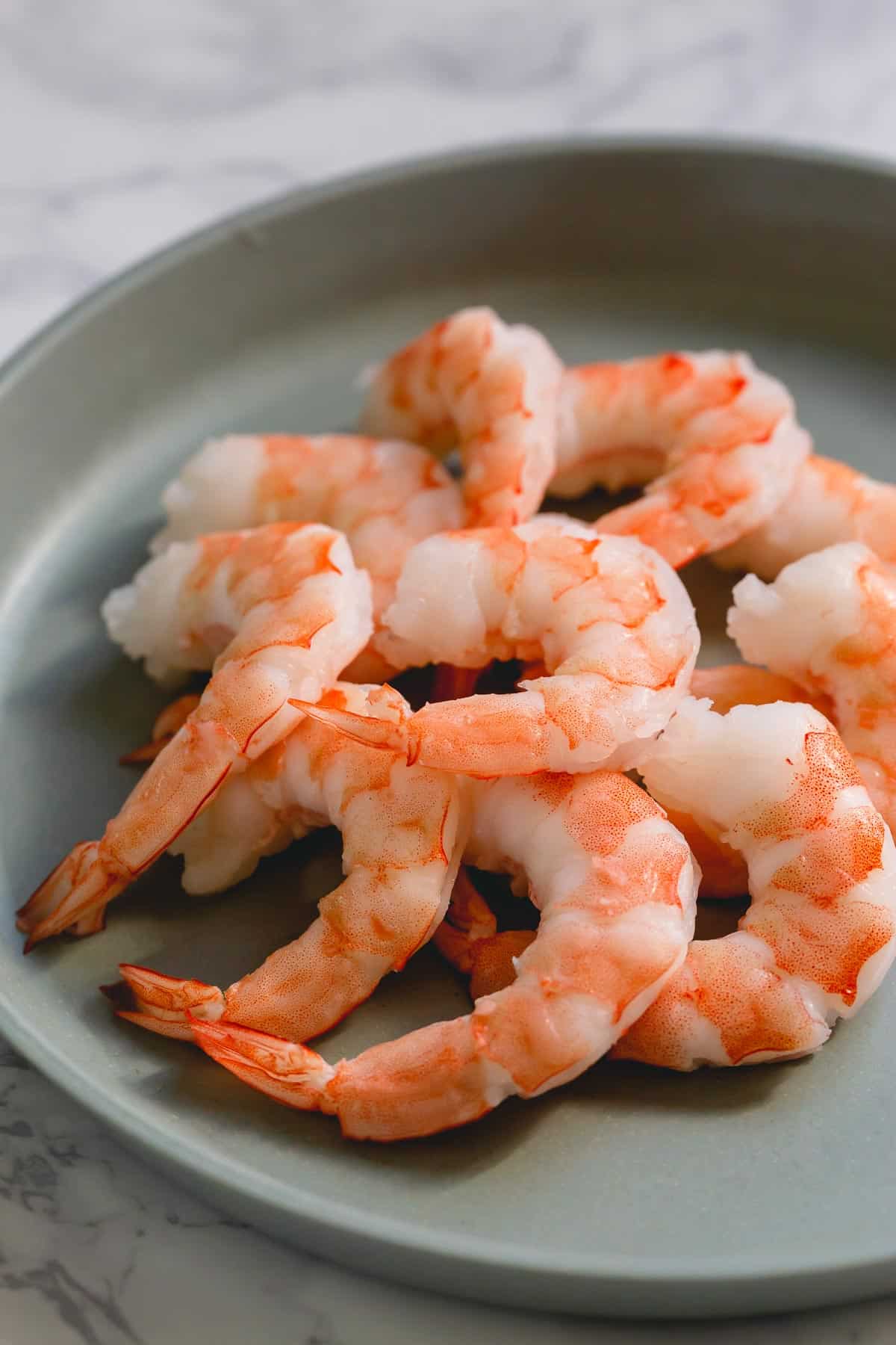 A pile of cooked shrimp on a plate