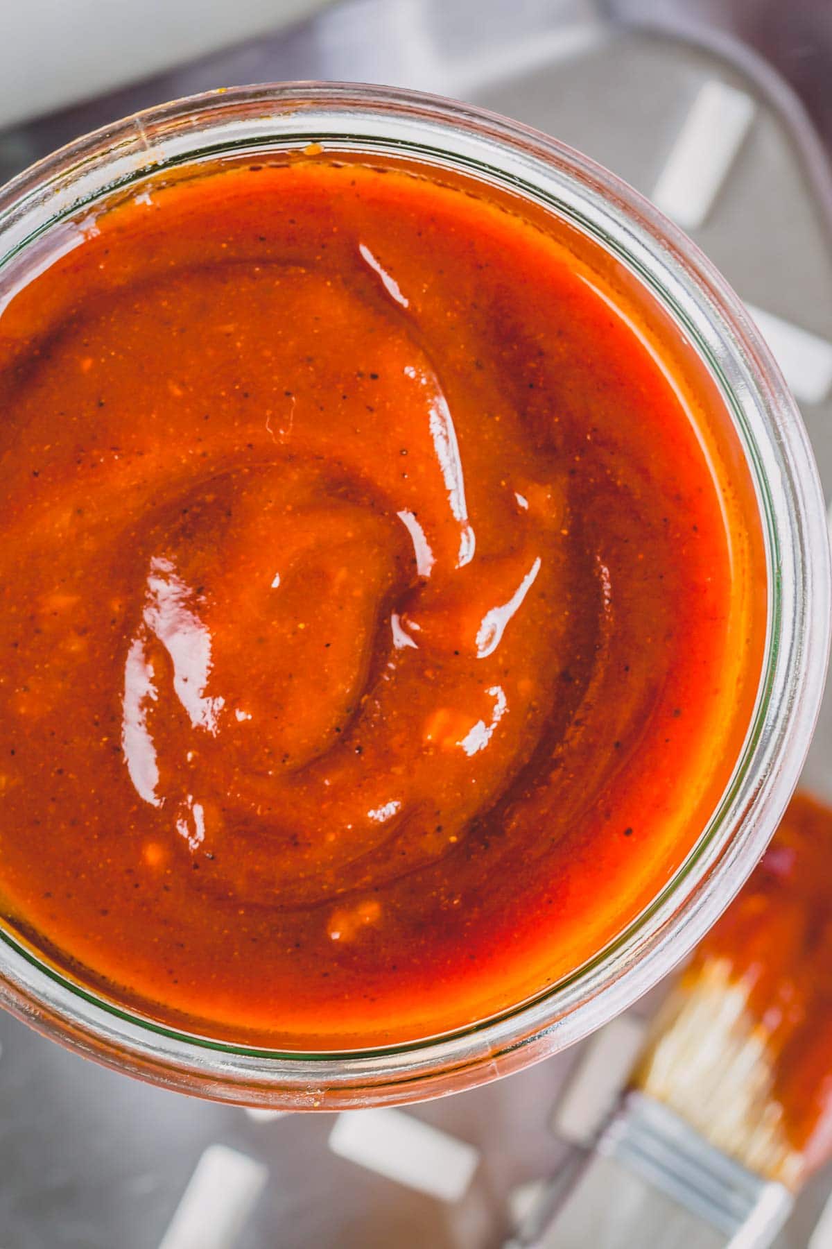 A close-up shot of jar of bbq sauce from the top.