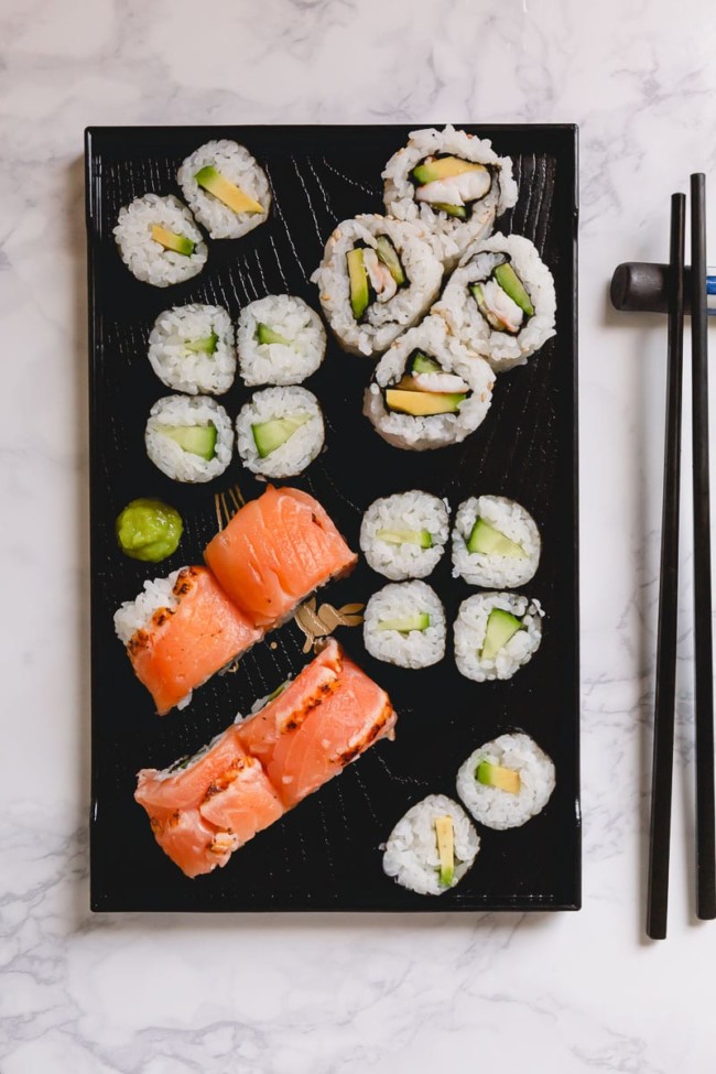 homemade sushi on a black mat