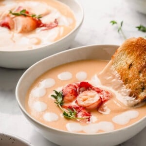 Lobster Bisque in bowl with bread stick
