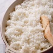 sushi rice in a dish with a wooden spoon