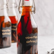 Homemade vanilla bean extract in a clear bottle.