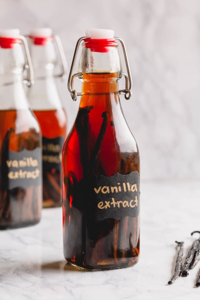 Homemade vanilla bean extract in a clear bottle.