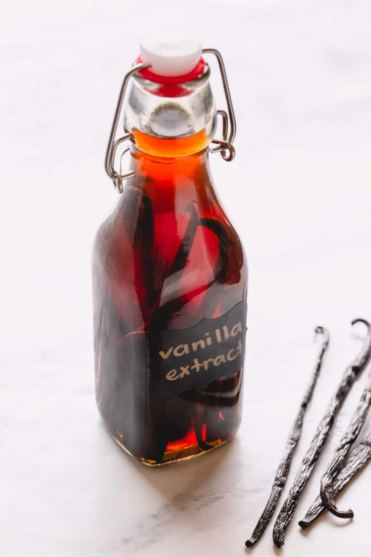 Homemade vanilla bean extract in a clear bottle.