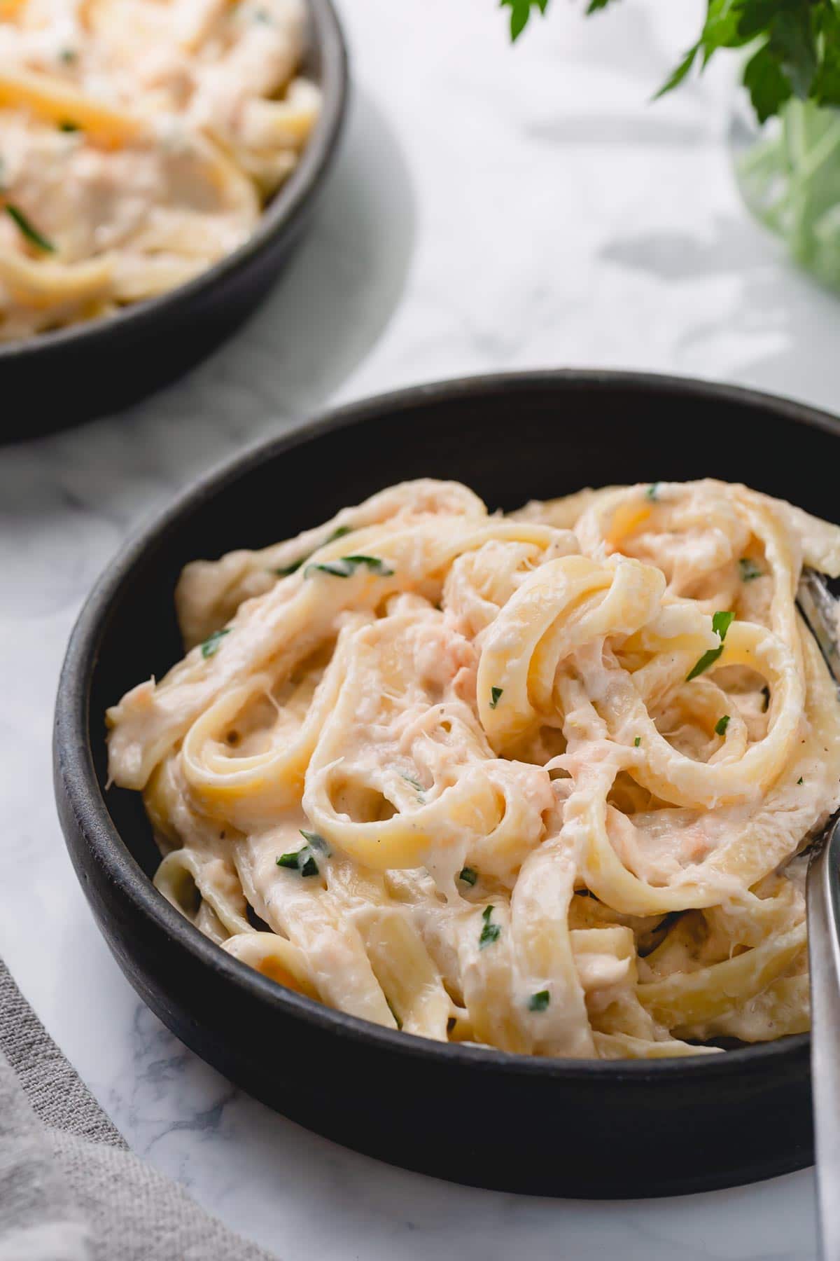 A plate of creamy pasta with smoked salmon.