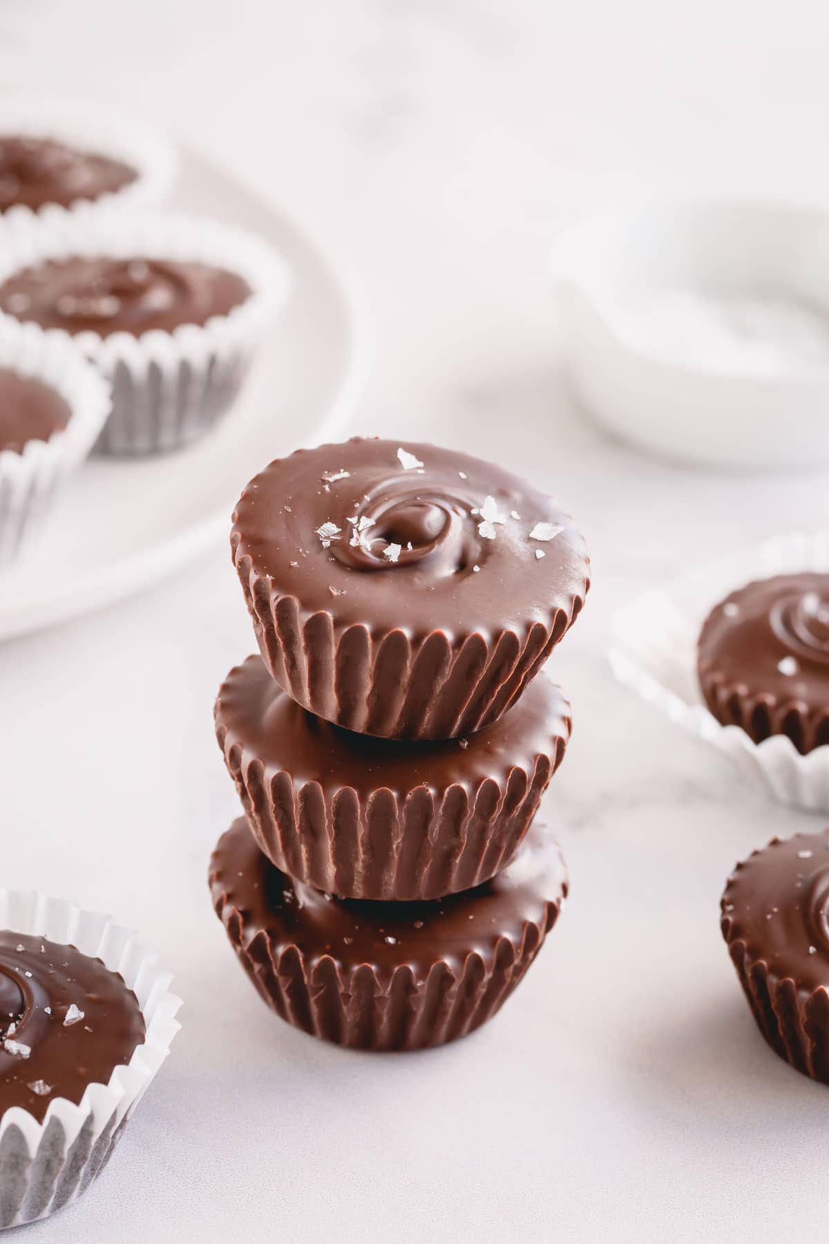 3 chocolate cups with sprinkle of salt flakes stacked on top of each other.