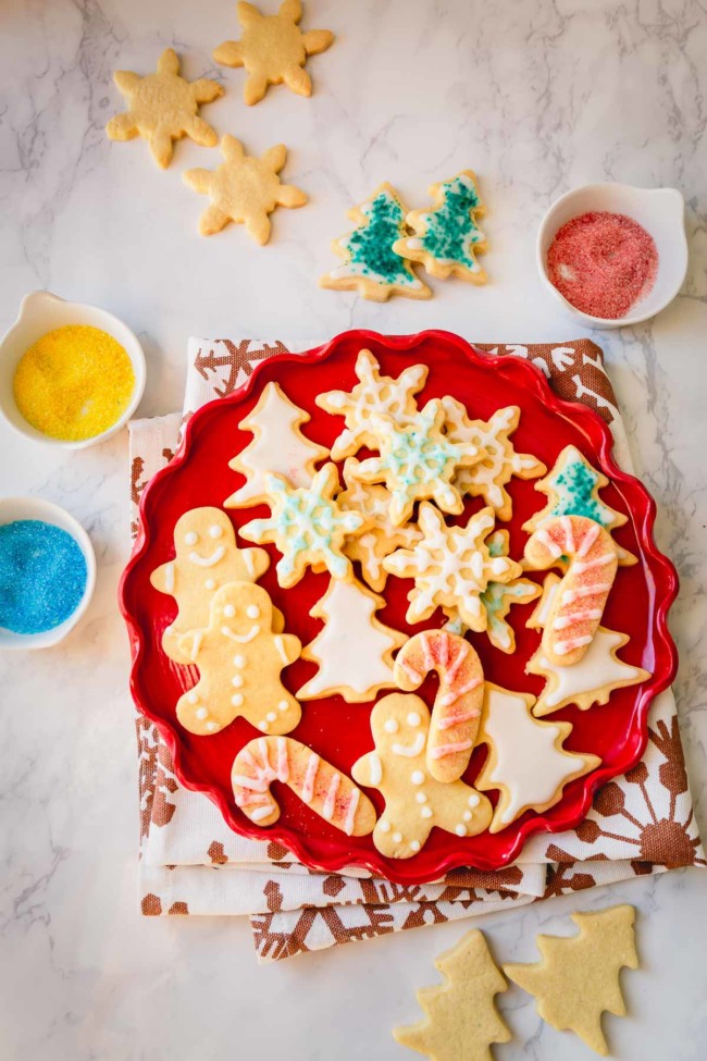 Decorated sugar cookies on a red platter.