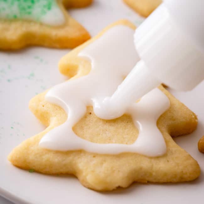 a process of glazing sugar cookie with an icing.