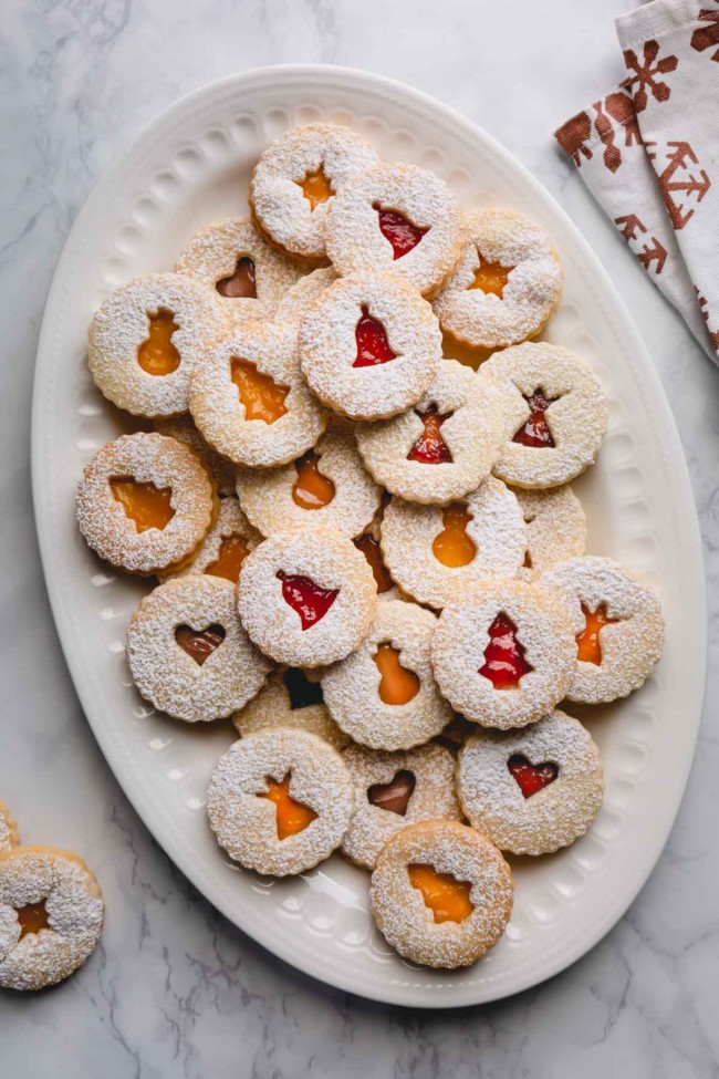Linzer cookies on a large white platter.