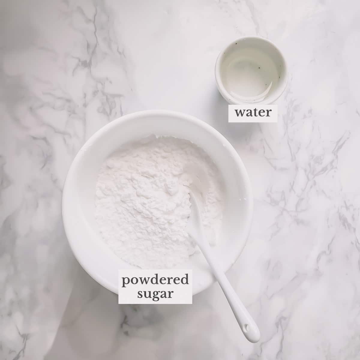 Powedered sugar and water in separate bowls.
