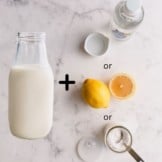 Bottle of milk with cream of tartar, white vinegar and lemon.