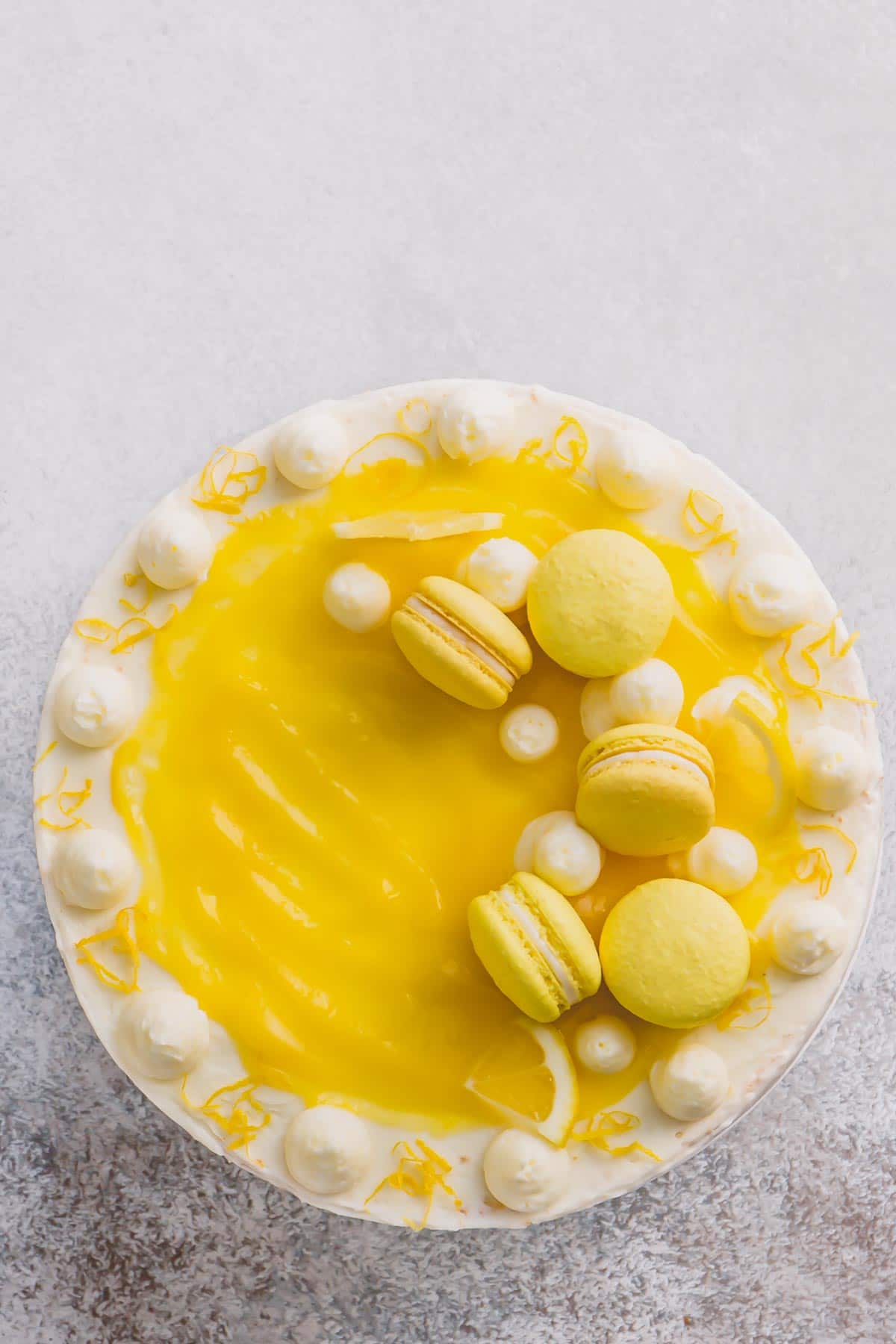Lemon layer cake, topped with lemon curd and lemon macarons.