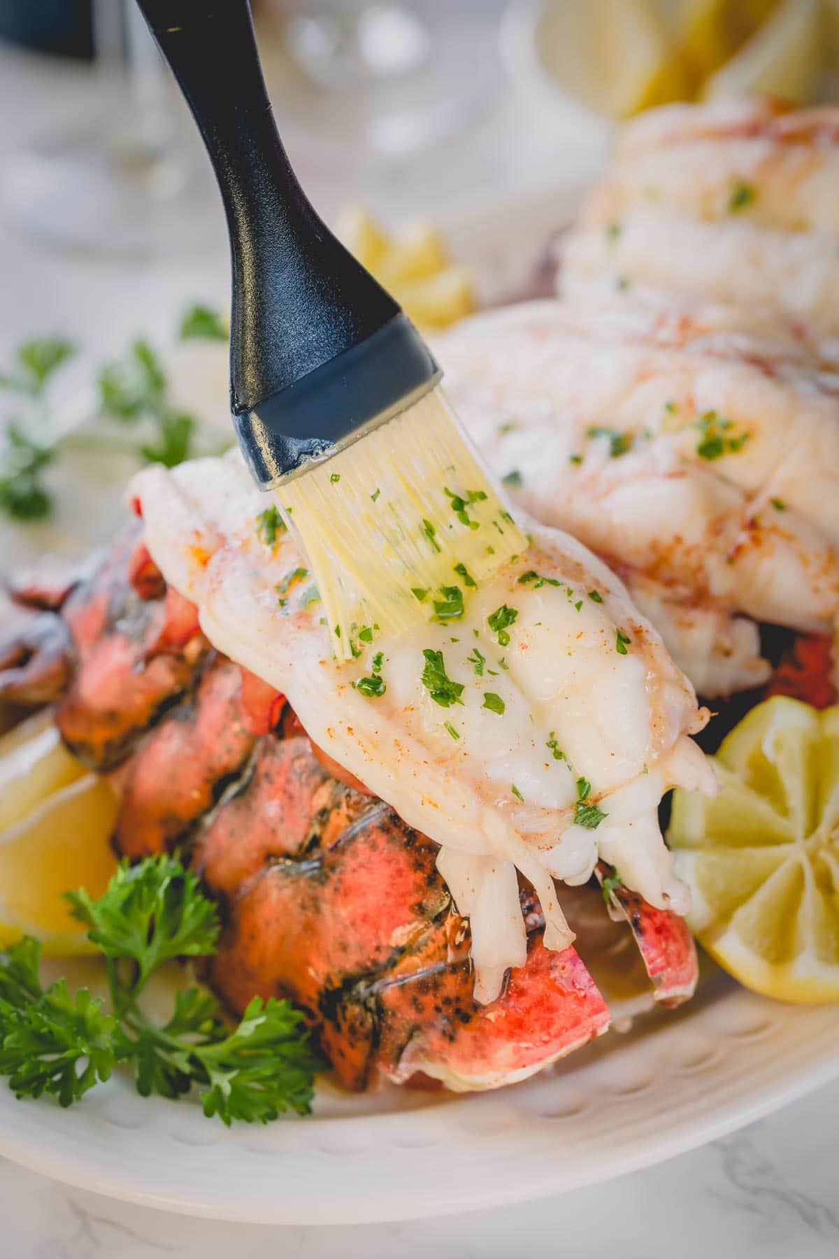 Brushing baked lobster meat with melted butter.