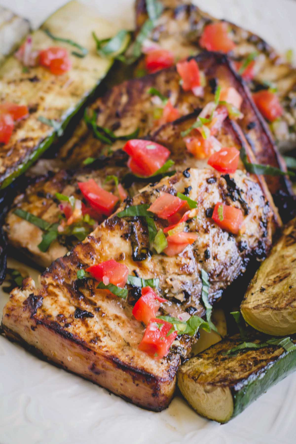 Grilled swordfish topped with chopped tomatoes and fresh herbs.