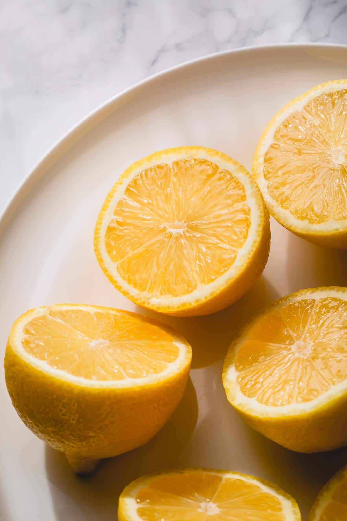 Lemon halves on a white plate.