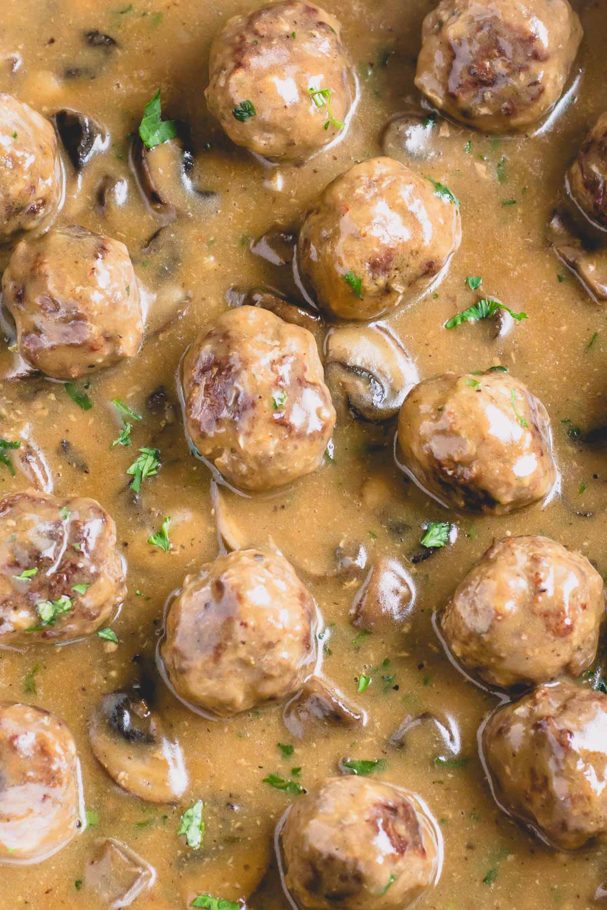 Beef meatballs in mushroom gravy topped with green herbs.