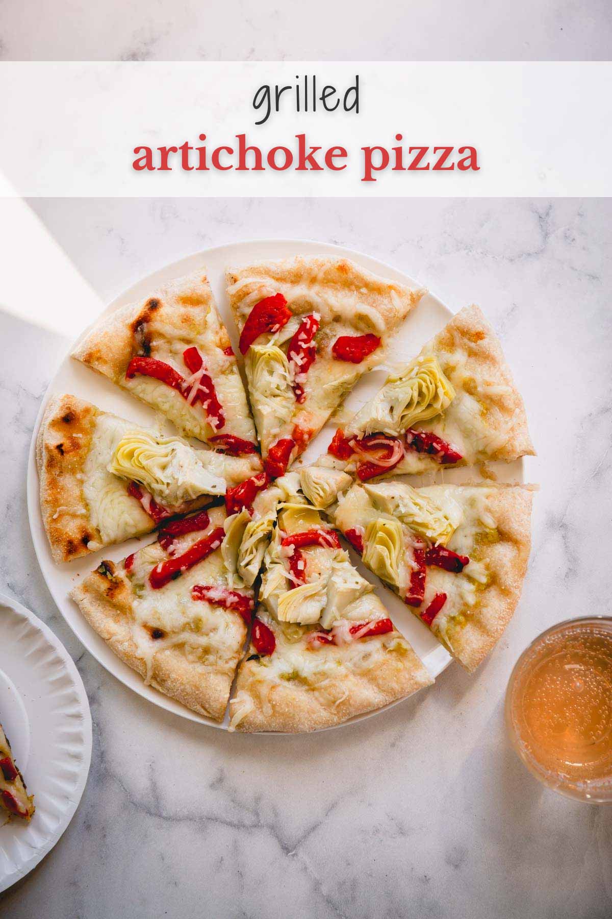 Sliced artichoke pizza on a white plate.