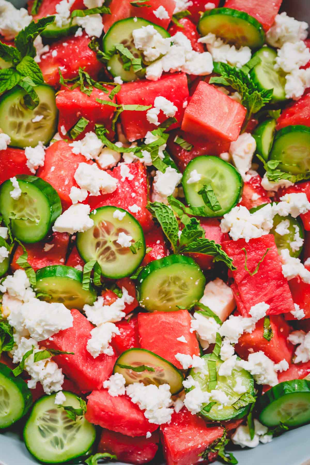 Upclose photo of watermelon feta cheese garnished with chopped fresh mint.
