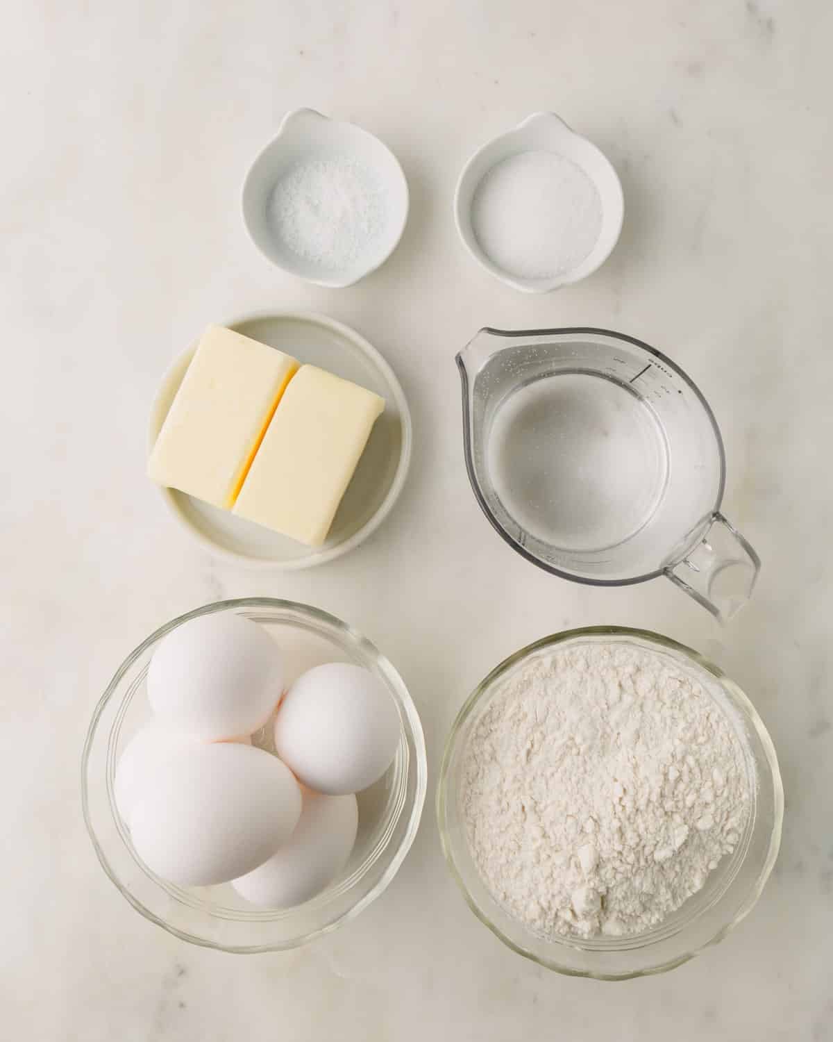 Choux pastry dough ingredients in individual bowls.