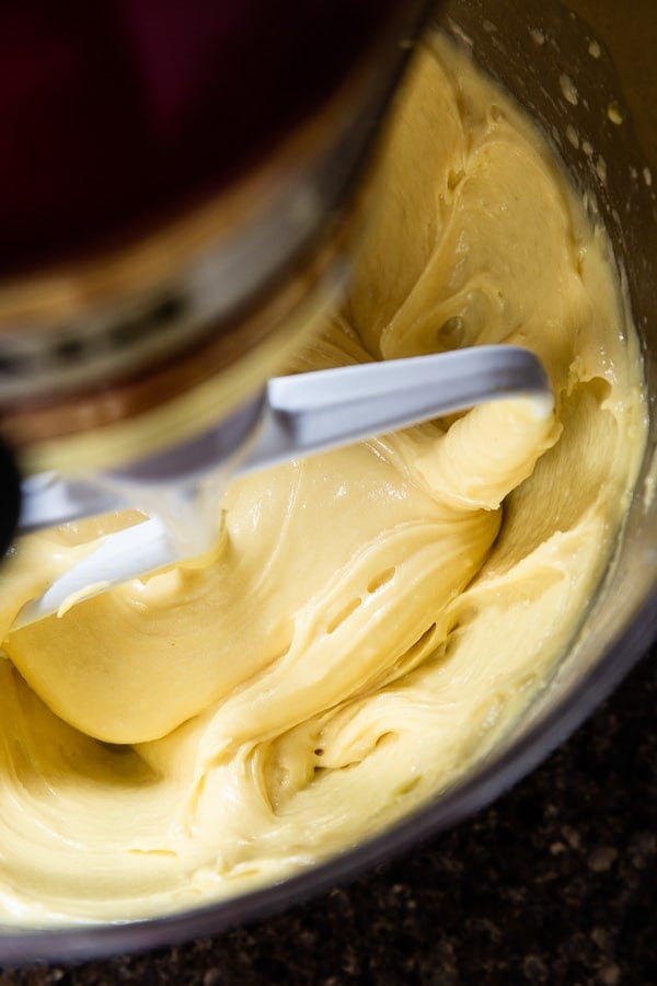Glossy choux dough in a mixing bowl with paddle attachment.