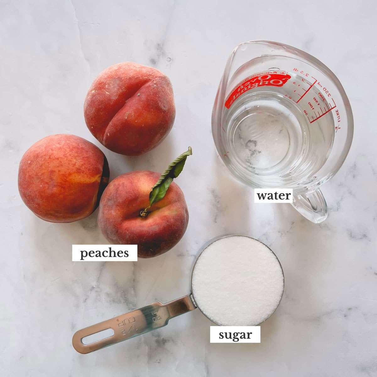 3 peaches, granulated sugar in a measuring cup and glass of water.