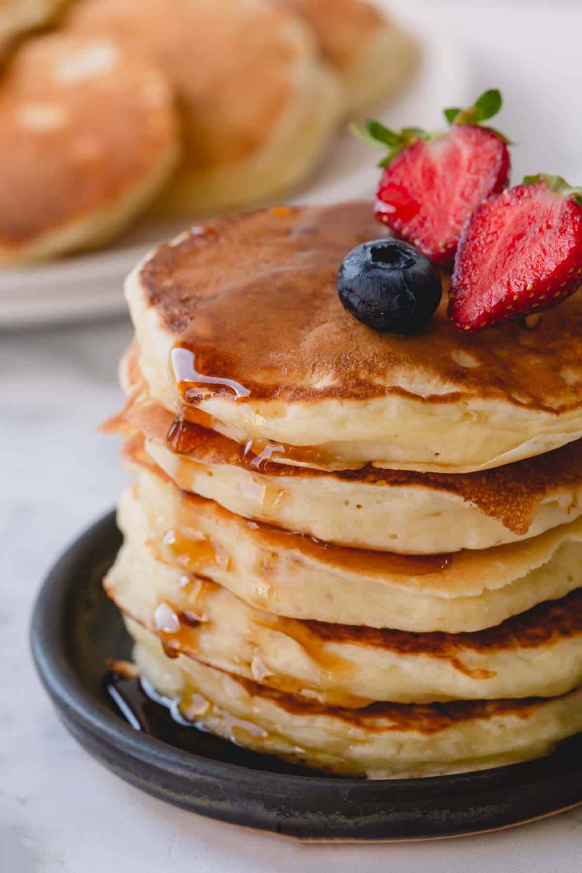 a stack of pancakes with fruit on top.