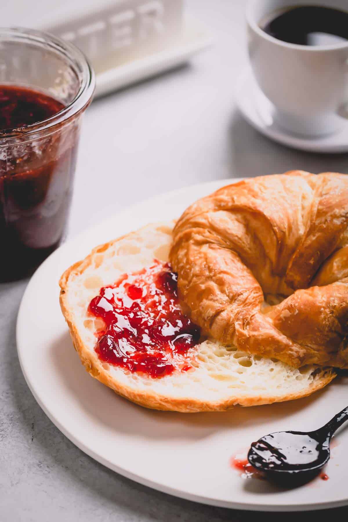 Sliced croissant with strawberry jam.