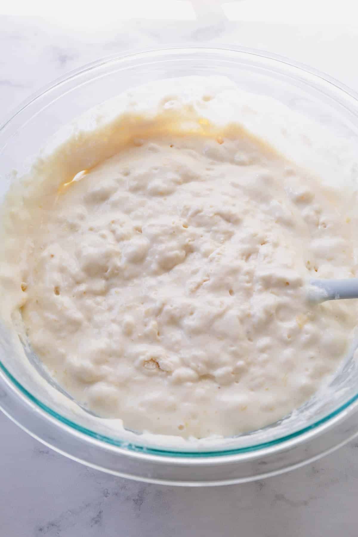 Lumpy pancake batter in a large mixing bowl.