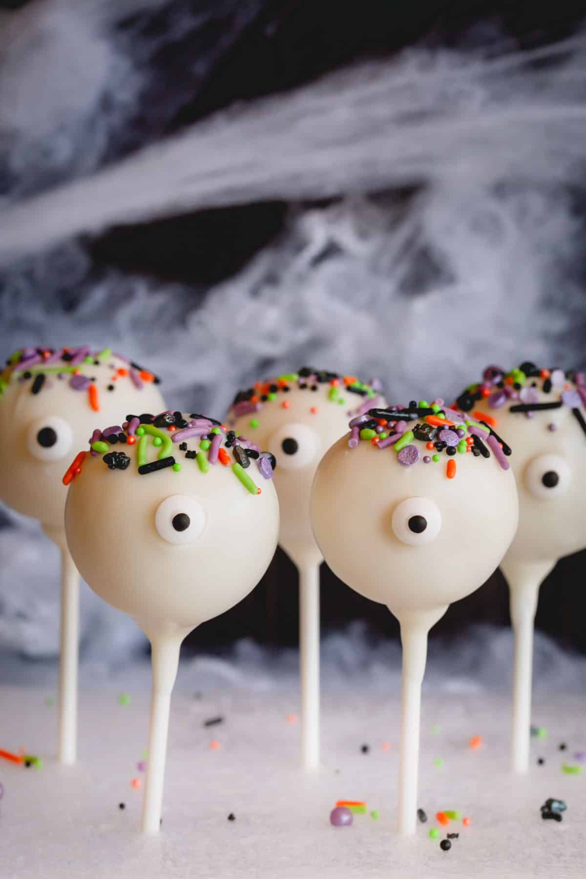 Halloween cake pops with sprinkles and candy eyes.