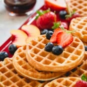 a stack of waffles with berries