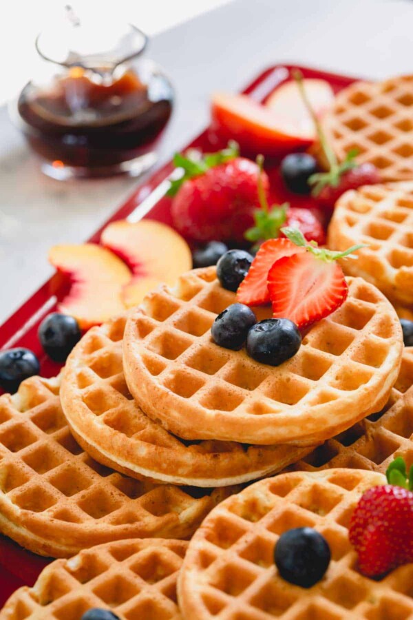 a stack of waffles with berries