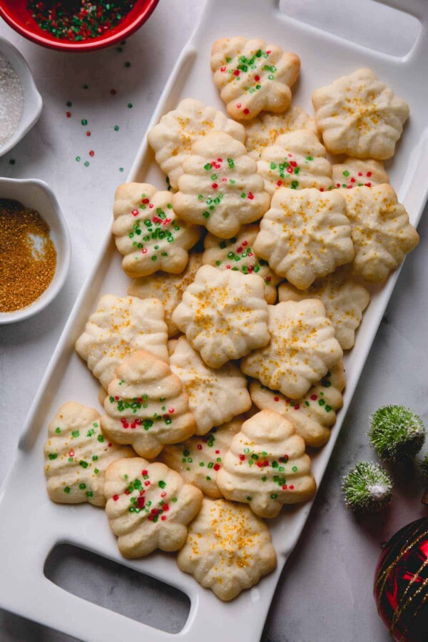 a plate of holiday shaped spritz cookies.