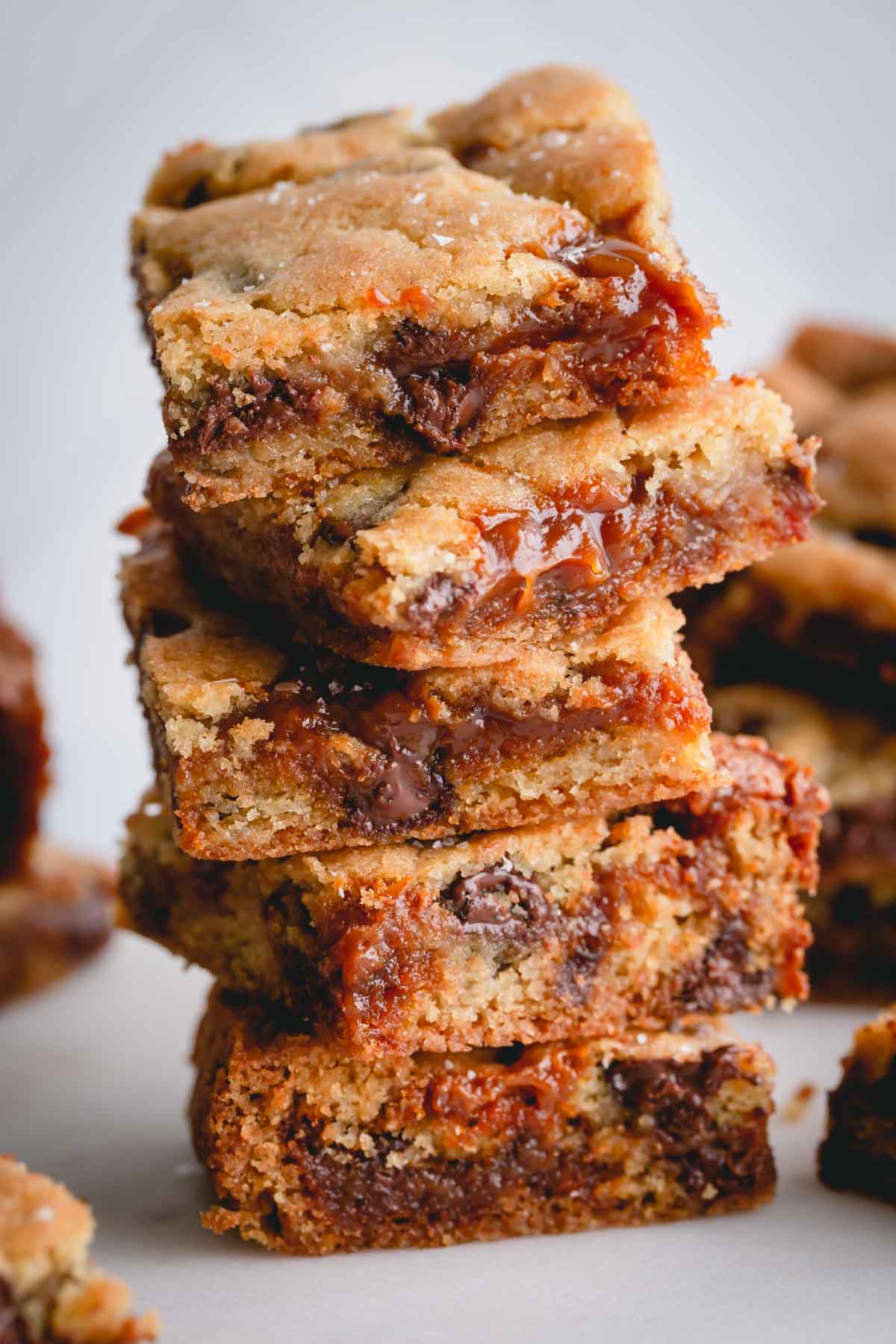 a stack of caramel chocolate chip cookie bars