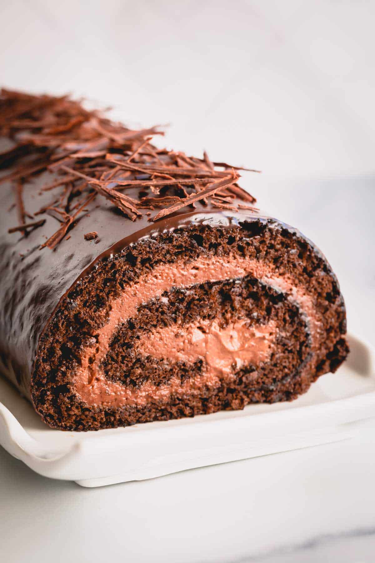 a chocolate roll cake with mousse in the middle.