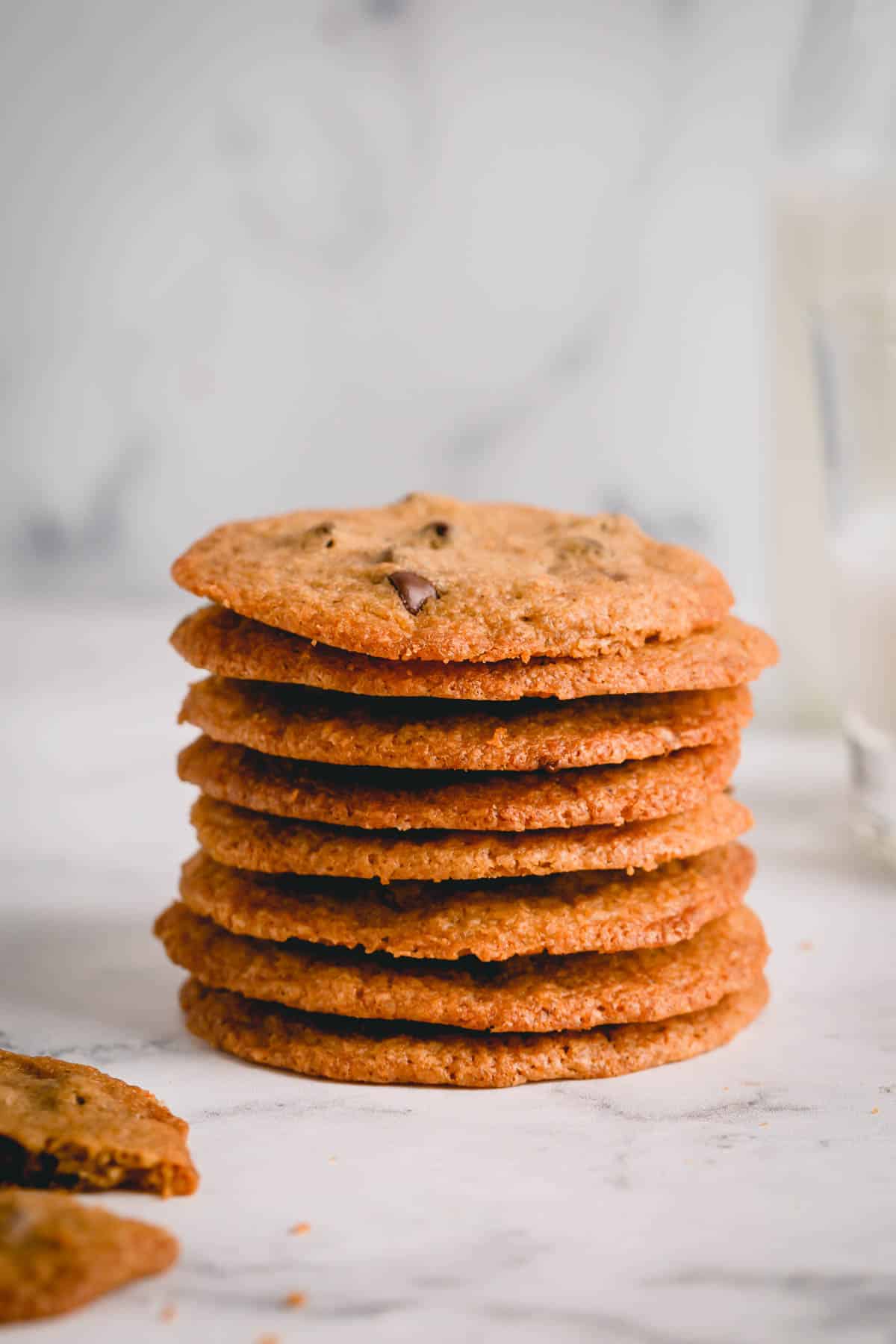 a stack of thin chocolate chip cookies.