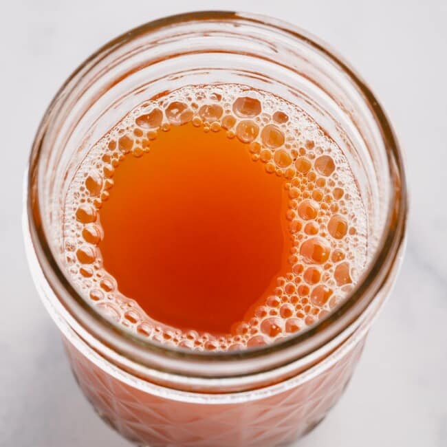Golden browned butter in a glass jar.