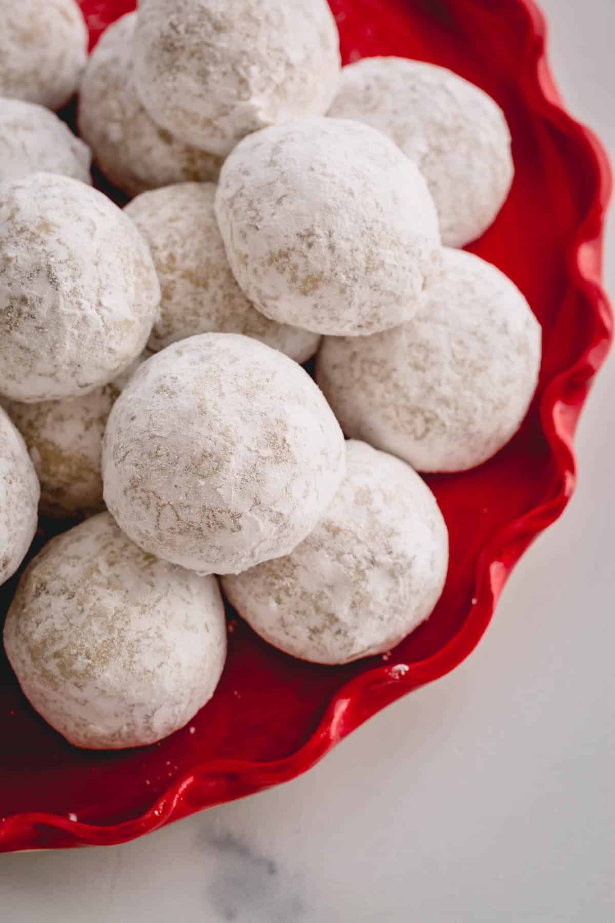 a plate of snowball cookies.