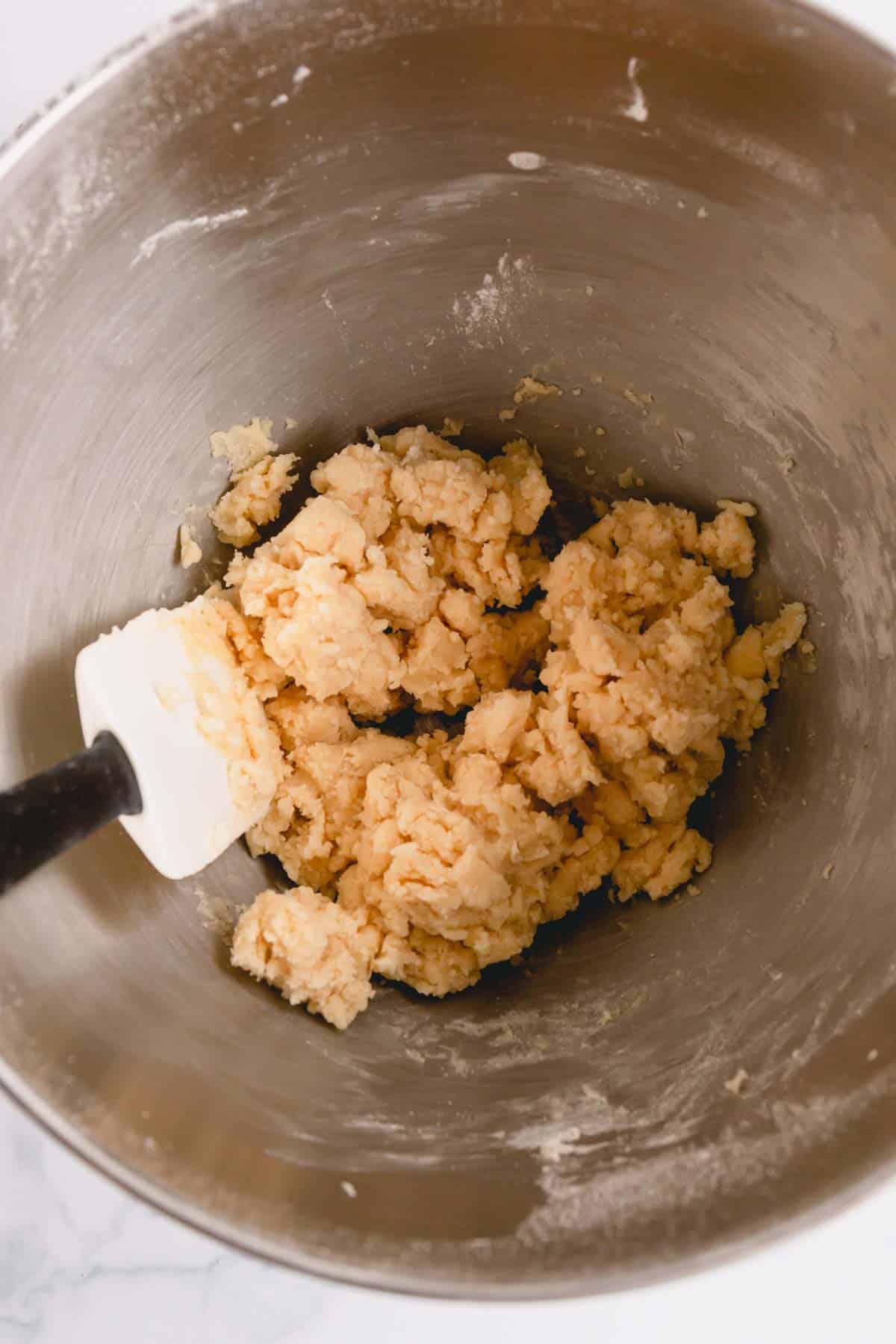 snowball cookie dough in a mixing bowl.