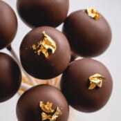 chocolate cake pops with gold luster.