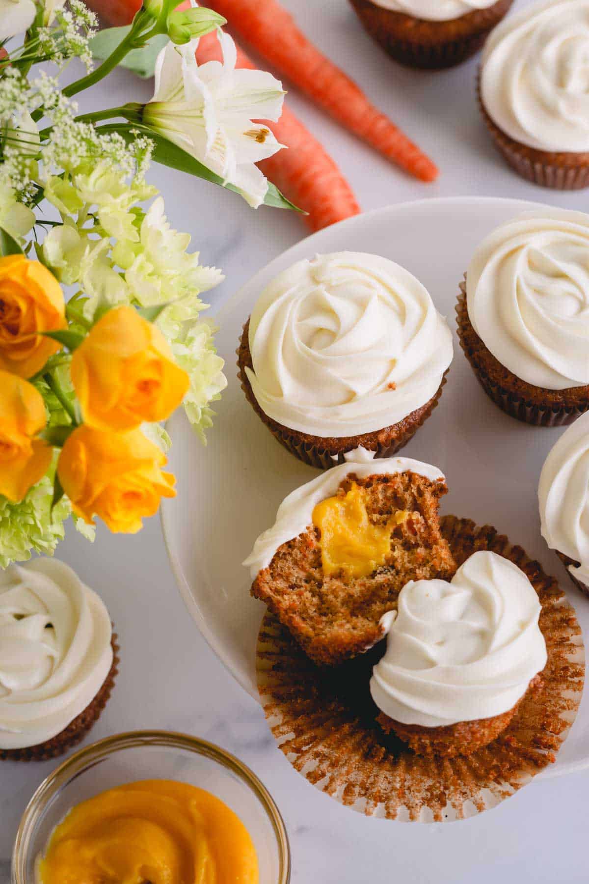 a frosted carrot cake cupcake cut in half.