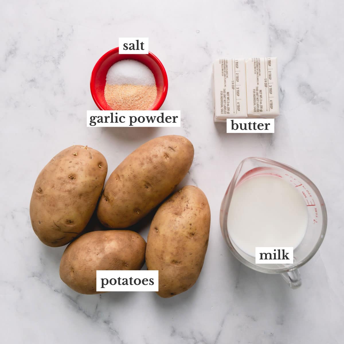 Potatoes, salt, garlic powder, butter, and milk to make brown butter mashed potatoes.