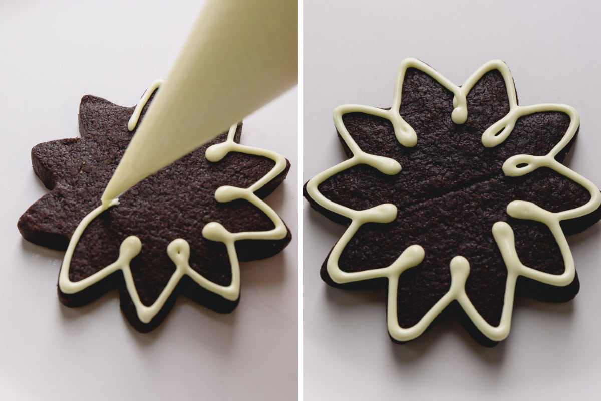 piping icing onto a chocolate star cookie.