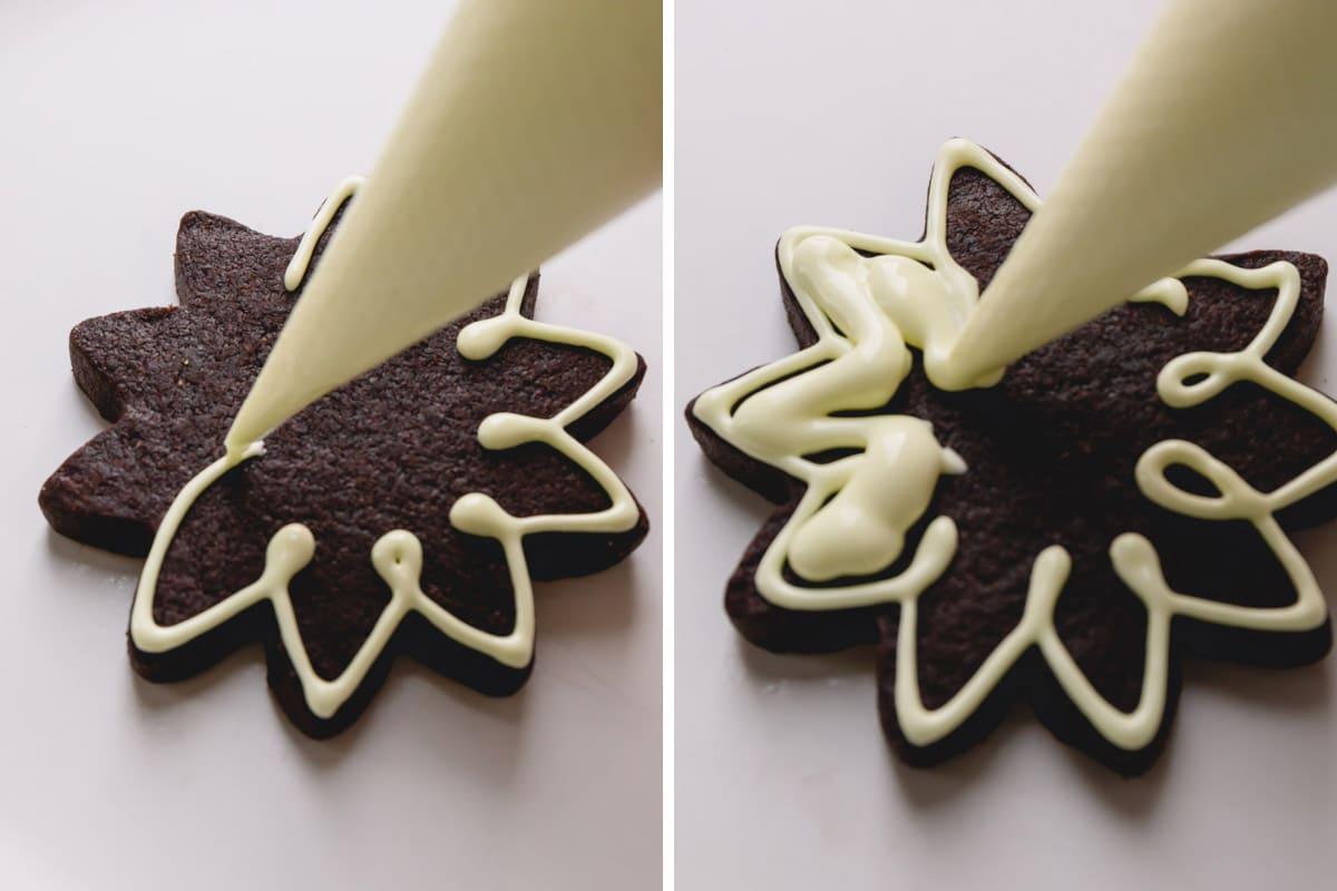 piping royal icing onto a chocolate cookie. 