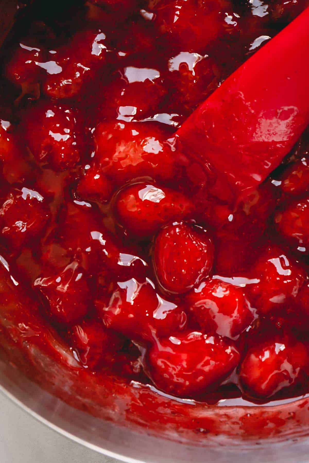 Close up image of chunky strawberry sauce.