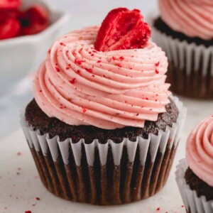 chocolate cupcake with strawberry buttercream and a strawberry.