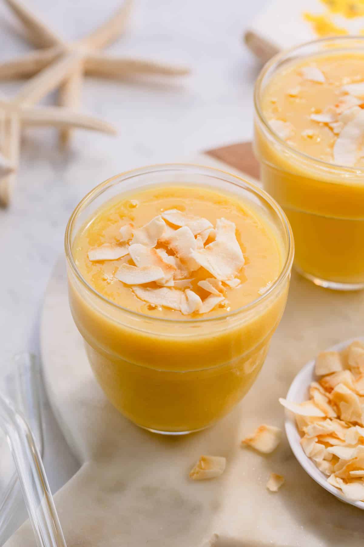 pineapple orange smoothie with coconut on top.