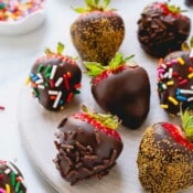 Chocolate covered strawberries coated with multi-color, chocolate, and gold sprinkles.
